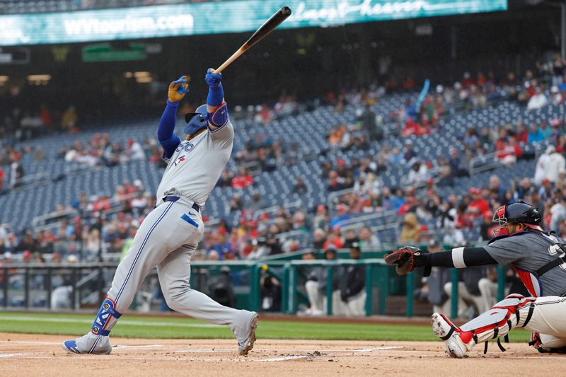 May 4, 2024; Washington, District of Columbia, USA; Toronto Blue Jays third baseman Justin Turner (2) hits an RBI single against the Washington Nationals during the first inning at Nationals Park. Mandatory Credit: Geoff Burke-USA TODAY Sports