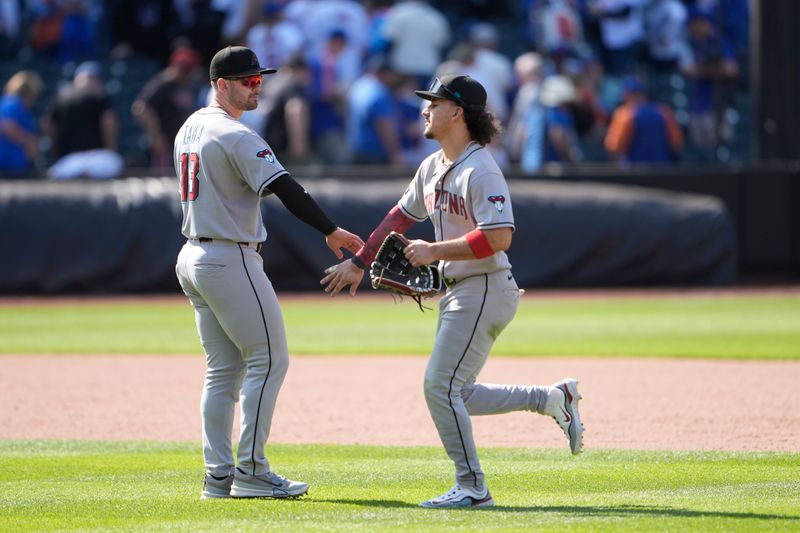 May 1, 2025; New York City, New York, USA; Arizona Diamondbacks second baseman Tim Tawa (13) and center fielder Alek Thomas (5) celebrate the victory against the New York Mets after the ninth inning at Citi Field. Mandatory Credit: Gregory Fisher-Imagn Images