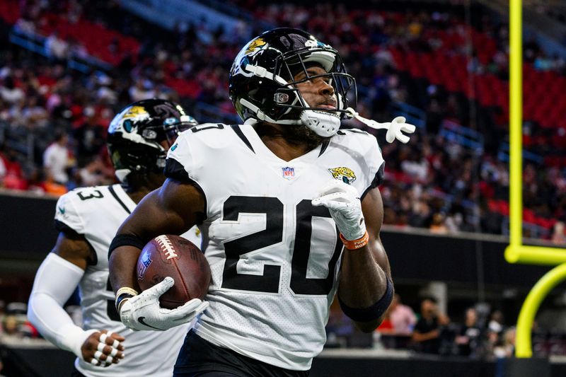 Jacksonville Jaguars safety Daniel Thomas (20) returns to the sideline after an interception during the first half of an NFL football game against the Atlanta Falcons, Saturday, Aug. 27, 2022, in Atlanta. The Atlanta Falcons won 28-12. (AP Photo/Danny Karnik)