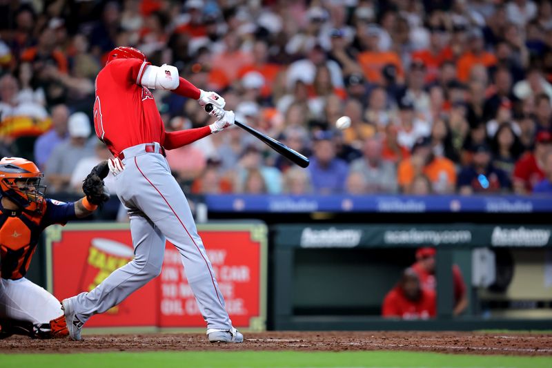 Aug 13, 2023; Houston, Texas, USA; Los Angeles Angels designated hitter Shohei Ohtani (17) hits a home run to center field against the Houston Astros during the sixth inning at Minute Maid Park. Mandatory Credit: Erik Williams-USA TODAY Sports