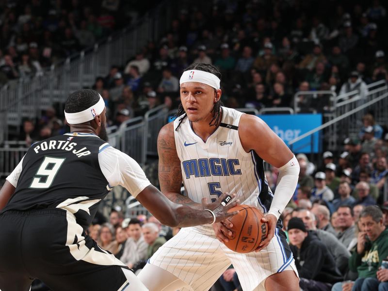 MILWAUKEE, WI - JANUARY 15:  Paolo Banchero #5 of the Orlando Magic handles the ball during the game against the Milwaukee Bucks on January 15, 2025 at Fiserv Forum Center in Milwaukee, Wisconsin. NOTE TO USER: User expressly acknowledges and agrees that, by downloading and or using this Photograph, user is consenting to the terms and conditions of the Getty Images License Agreement. Mandatory Copyright Notice: Copyright 2025 NBAE (Photo by Gary Dineen/NBAE via Getty Images).