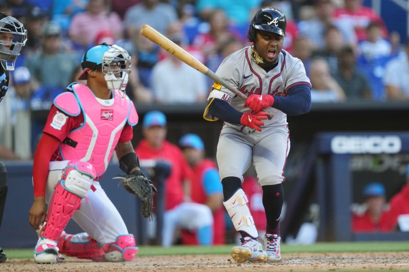 Apr 13, 2024; Miami, Florida, USA;  Atlanta Braves second base Ozzie Albies (1) goes down after fouling a ball off of his foot inn the eighth against the Miami Marlins at loanDepot Park. Mandatory Credit: Jim Rassol-USA TODAY Sports