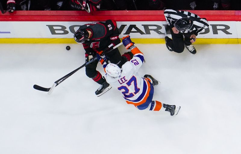 Apr 20, 2024; Raleigh, North Carolina, USA; Carolina Hurricanes center Martin Necas (88) is checked by New York Islanders left wing Anders Lee (27) during the third period in game one of the first round of the 2024 Stanley Cup Playoffs at PNC Arena. Mandatory Credit: James Guillory-USA TODAY Sports