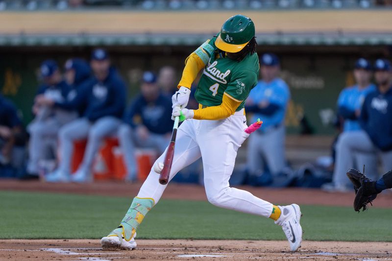 Aug 19, 2024; Oakland, California, USA; Oakland Athletics outfielder Lawrence Butler (4) hits a single during the first inning against the Tampa Bay Rays at Oakland-Alameda County Coliseum. Mandatory Credit: Stan Szeto-USA TODAY Sports