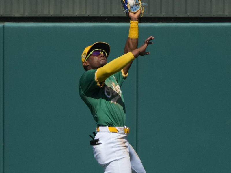 Mar 10, 2024; Mesa, Arizona, USA; Oakland Athletics center fielder Esteury Ruiz (1) makes the leaping catch for an out against the Kansas City Royals in the second inning at Hohokam Stadium. Mandatory Credit: Rick Scuteri-USA TODAY Sports