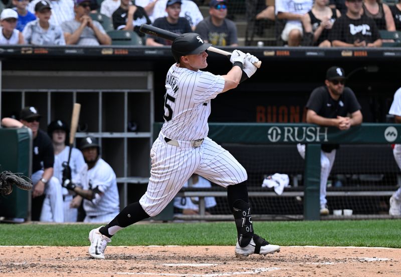 Jun 20, 2024; Chicago, Illinois, USA;  Chicago White Sox first base Andrew Vaughn (25) hits an RBI single against the Houston Astros during the fifth inning at Guaranteed Rate Field. Mandatory Credit: Matt Marton-USA TODAY Sports