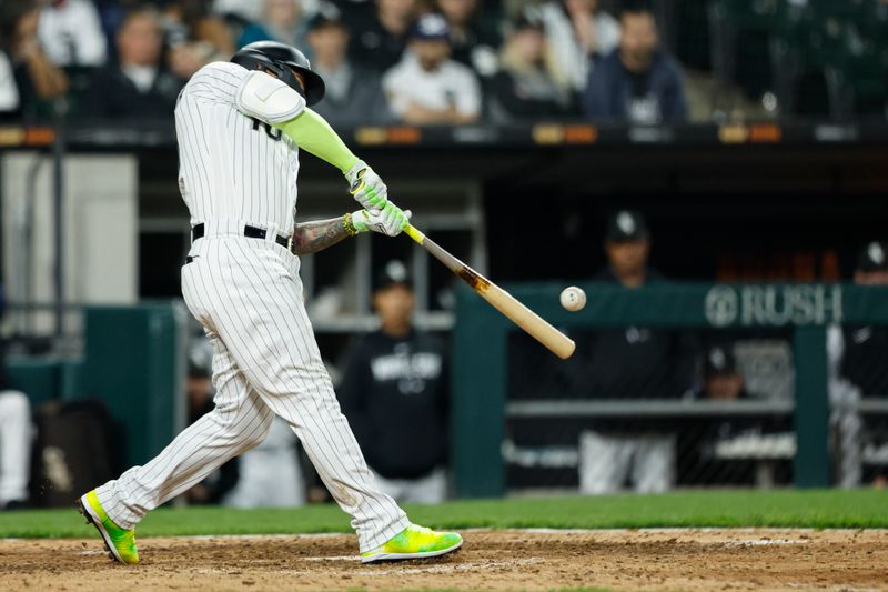 May 13, 2023; Chicago, Illinois, USA; Chicago White Sox third baseman Yoan Moncada (10) doubles against the Houston Astros during the eight inning at Guaranteed Rate Field. Mandatory Credit: Kamil Krzaczynski-USA TODAY Sports