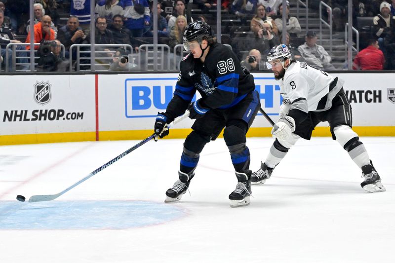 Jan 2, 2024; Los Angeles, California, USA; Toronto Maple Leafs right wing William Nylander (88) gets past Los Angeles Kings defenseman Drew Doughty (8) to score on an empty net in the third period at Crypto.com Arena. Mandatory Credit: Jayne Kamin-Oncea-USA TODAY Sports