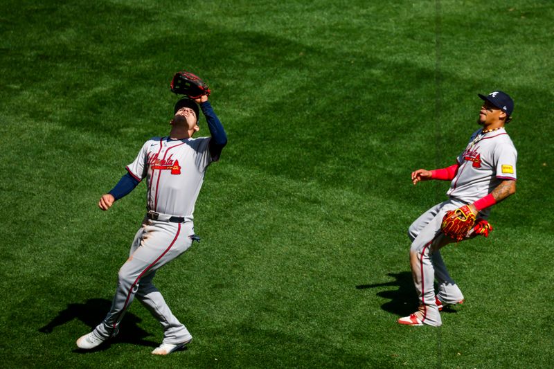 May 1, 2024; Seattle, Washington, USA; Atlanta Braves third baseman Austin Riley (27, left) catches a pop-out against the Seattle Mariners during the eighth inning at T-Mobile Park. Atlanta Braves shortstop Orlando Arcia (11) follows the play at right. Mandatory Credit: Joe Nicholson-USA TODAY Sports