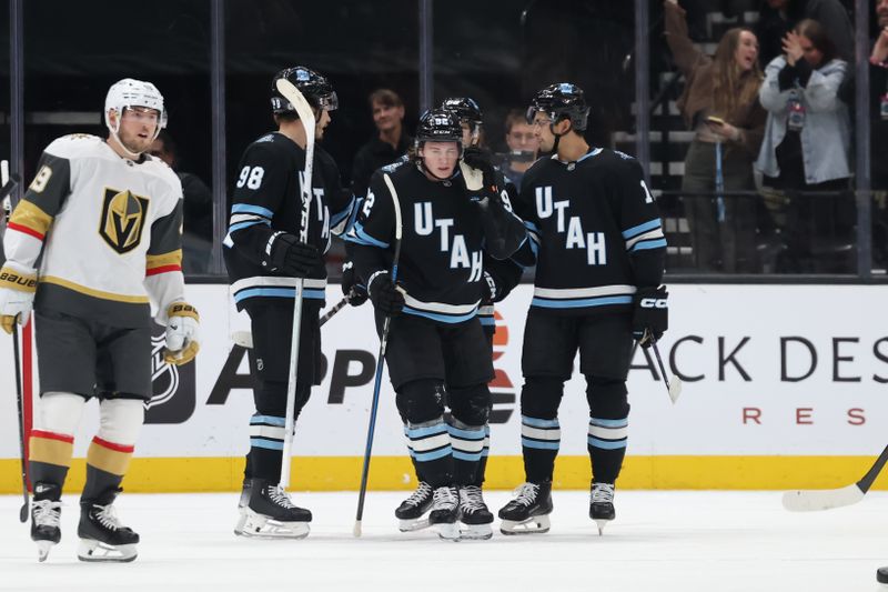 Nov 15, 2024; Salt Lake City, Utah, USA; Utah Hockey Club center Logan Cooley (center) celebrates scoring a goal against the Vegas Golden Knights during the first period at Delta Center. Mandatory Credit: Rob Gray-Imagn Images