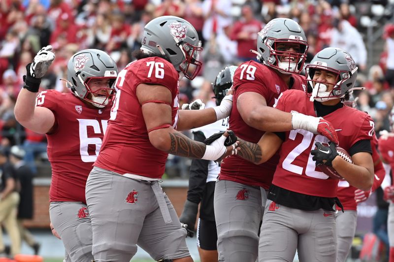 Oct 19, 2024; Pullman, Washington, USA; Washington State Cougars running back Leo Pulalasi (20) and offensive lineman Fa'alili Fa'amoe (79) celebrate after a touchdown against the Hawaii Warriors in the second half at Gesa Field at Martin Stadium. Washington State won 42-10. Mandatory Credit: James Snook-Imagn Images