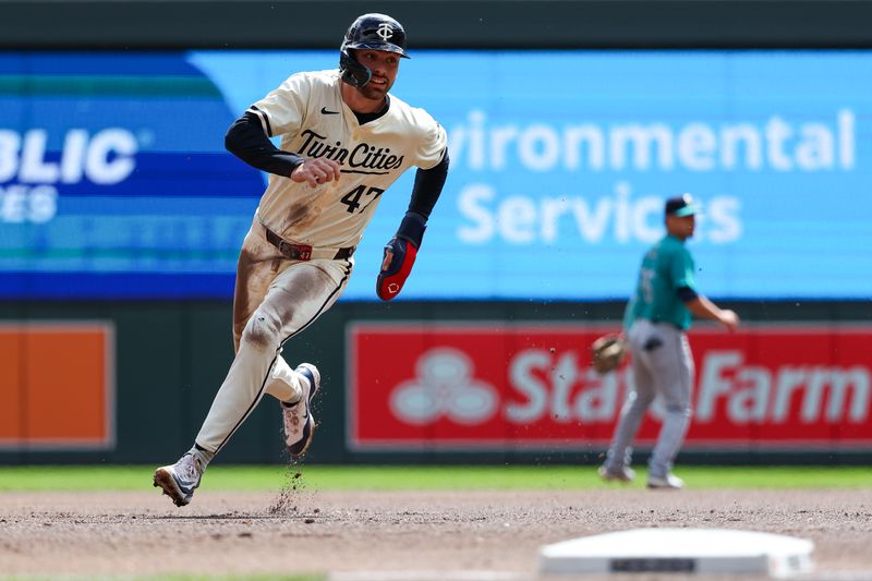 May 9, 2024; Minneapolis, Minnesota, USA; Minnesota Twins Edouard Julien (47) advances to third base on a single hit by Trevor Larnach (9) during the first inning against the Seattle Mariners at Target Field. Mandatory Credit: Matt Krohn-USA TODAY Sports