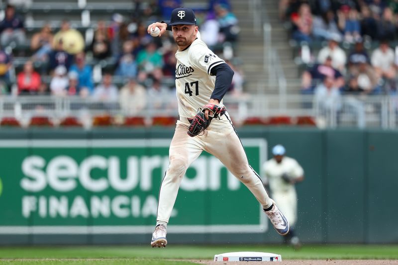 May 9, 2024; Minneapolis, Minnesota, USA; Minnesota Twins second baseman Edouard Julien (47) turns a double play against the Seattle Mariners during the seventh inning at Target Field. Mandatory Credit: Matt Krohn-USA TODAY Sports