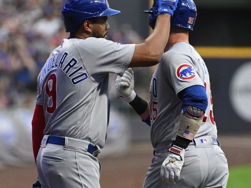 Sep 30, 2023; Milwaukee, Wisconsin, USA; Chicago Cubs third baseman Jeimer Candelario (9) congratulates Chicago Cubs catcher Yan Gomes (15) after Gomes a home run against the Milwaukee Brewers in the first inning at American Family Field. Mandatory Credit: Michael McLoone-USA TODAY Sports