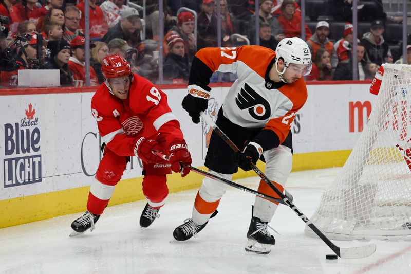 Jan 25, 2024; Detroit, Michigan, USA;  Philadelphia Flyers left wing Noah Cates (27) skates with the puck chased by Detroit Red Wings center Andrew Copp (18) in the third period at Little Caesars Arena. Mandatory Credit: Rick Osentoski-USA TODAY Sports