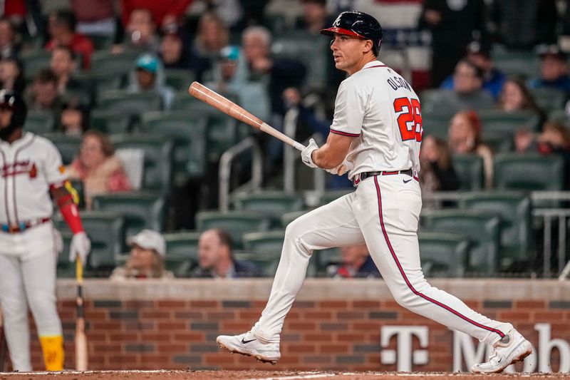 Apr 5, 2024; Cumberland, Georgia, USA; Atlanta Braves first base Matt Olson (28) hits a double to drive in a run against the Arizona Diamondbacks during the ninth inning at Truist Park. Mandatory Credit: Dale Zanine-USA TODAY Sports