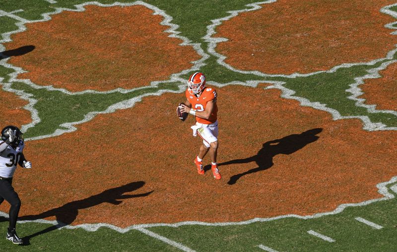 Oct 7, 2023; Clemson, South Carolina, USA; Clemson quarterback Cade Klubnik (2) runs by Wake Forest defensive lineman Jasheen Davis (30) during the second quarter at Memorial Stadium. Mandatory Credit: Ken Ruinard-USA TODAY Sports