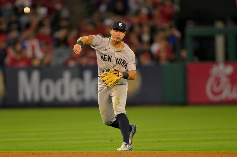May 29, 2024; Anaheim, California, USA; New York Yankees shortstop Anthony Volpe (11) throws Los Angeles Angels first baseman Nolan Schanuel (18) out at first in the sixth inning at Angel Stadium. Mandatory Credit: Jayne Kamin-Oncea-USA TODAY Sports