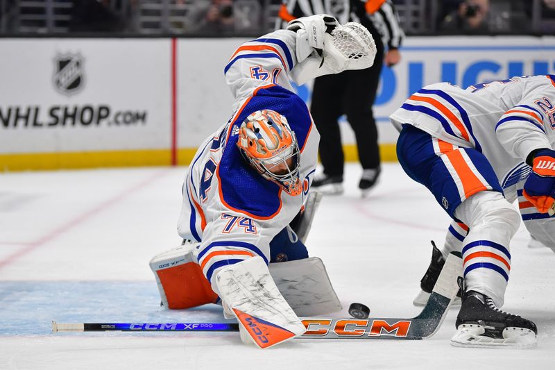 Dec 30, 2023; Los Angeles, California, USA; dEdmonton Oilers goaltender Stuart Skinner (74) blocks a shot against the Los Angeles Kings uring the second period at Crypto.com Arena. Mandatory Credit: Gary A. Vasquez-USA TODAY Sports