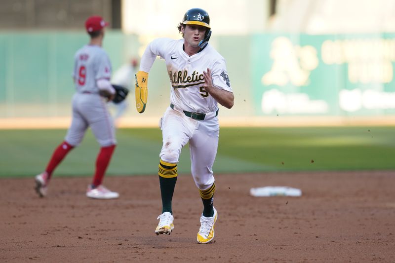 Jul 19, 2024; Oakland, California, USA; Oakland Athletics shortstop Jacob Wilson (5) runs towards third base before scoring a run against the Los Angeles Angels in the third inning at Oakland-Alameda County Coliseum. Mandatory Credit: Cary Edmondson-USA TODAY Sports