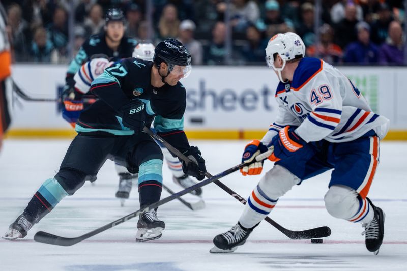 Oct 25, 2025; Seattle, Washington, USA; Seattle Kraken forward Jaden Schwartz (17) skates against Edmonton Oilers defenseman Ty Emberson (49) during the second period at Climate Pledge Arena. Mandatory Credit: Stephen Brashear-Imagn Images