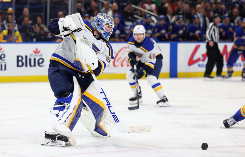 Nov 14, 2024; Buffalo, New York, USA;  St. Louis Blues goaltender Jordan Binnington (50) clears the puck during the second period against the Buffalo Sabres at KeyBank Center. Mandatory Credit: Timothy T. Ludwig-Imagn Images