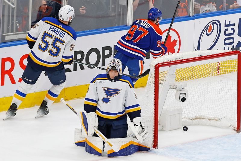 Feb 28, 2024; Edmonton, Alberta, CAN; Edmonton Oilers forward Connor McDavid (97) scores the game wining goal during overtime against St. Louis Blues goaltender Jordan Binnington (50) at Rogers Place. Mandatory Credit: Perry Nelson-USA TODAY Sports