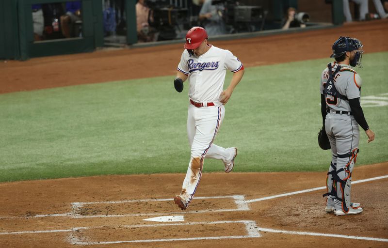 Jun 28, 2023; Arlington, Texas, USA;  Texas Rangers shortstop Corey Seager (5) scores during the first inning against the Detroit Tigers at Globe Life Field. Mandatory Credit: Kevin Jairaj-USA TODAY Sports