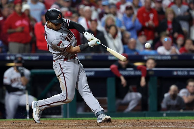 Oct 24, 2023; Philadelphia, Pennsylvania, USA; Arizona Diamondbacks catcher Gabriel Moreno (14) hits a RBI single against the Philadelphia Phillies in the fifth inning for game seven of the NLCS for the 2023 MLB playoffs at Citizens Bank Park. Mandatory Credit: Bill Streicher-USA TODAY Sports