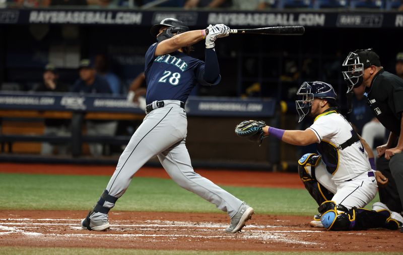 Sep 8, 2023; St. Petersburg, Florida, USA; Seattle Mariners third baseman Eugenio Suarez (28) hits a home run against the Tampa Bay Rays during the second inning at Tropicana Field. Mandatory Credit: Kim Klement Neitzel-USA TODAY Sports