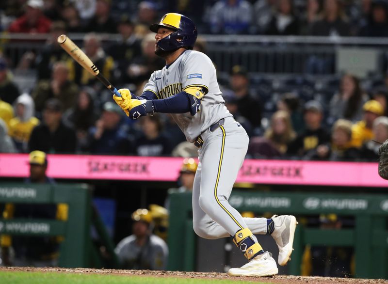May 23, 2025; Pittsburgh, Pennsylvania, USA;  Milwaukee Brewers center fielder Jackson Chourio (11) hits an RBI single against the Pittsburgh Pirates during the seventh inning at PNC Park. Mandatory Credit: Charles LeClaire-Imagn Images
