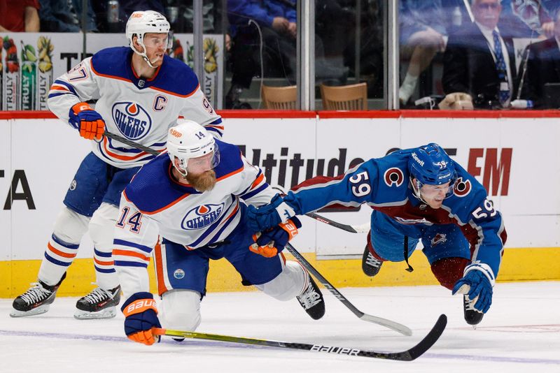 Apr 11, 2023; Denver, Colorado, USA; Colorado Avalanche center Ben Meyers (59) gets pulled down by Edmonton Oilers defenseman Mattias Ekholm (14) as center Connor McDavid (97) defends in the second period at Ball Arena. Mandatory Credit: Isaiah J. Downing-USA TODAY Sports