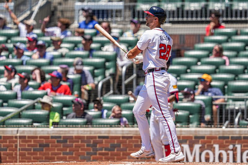 May 20, 2024; Cumberland, Georgia, USA; Atlanta Braves first baseman Matt Olson (28) watches the ball after hitting a home run against the San Diego Padres during the third inning at Truist Park. Mandatory Credit: Dale Zanine-USA TODAY Sports