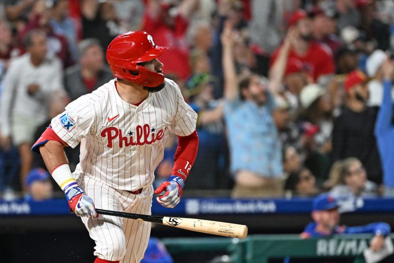 Sep 9, 2025; Philadelphia, Pennsylvania, USA; Philadelphia Phillies outfielder Kyle Schwarber (12) watches his 50th home run of the year during the seventh inning against the New York Mets at Citizens Bank Park. Mandatory Credit: Eric Hartline-Imagn Images