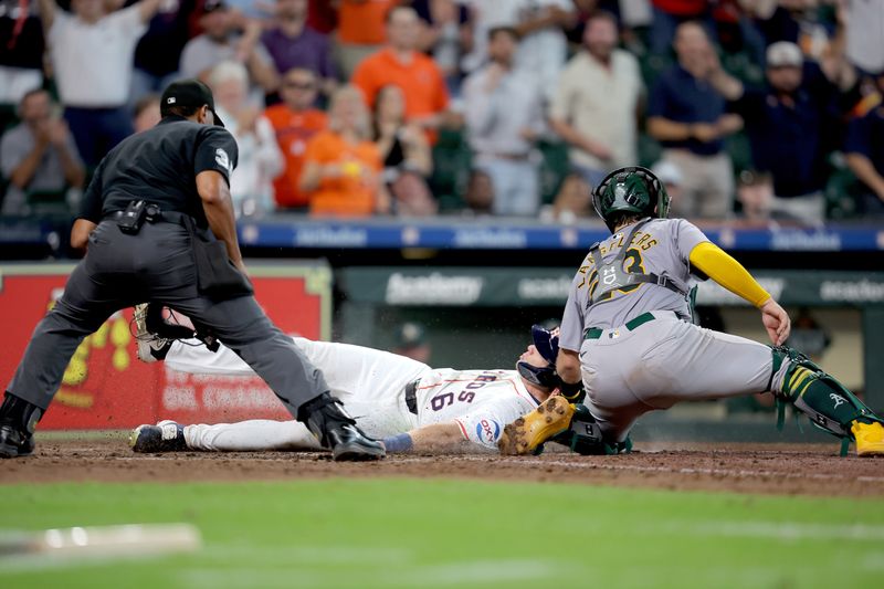 Sep 12, 2024; Houston, Texas, USA; Houston Astros center fielder Jake Meyers (6) slides into home plate to score a run against the Oakland Athletics during the eighth inning at Minute Maid Park. Mandatory Credit: Erik Williams-Imagn Images