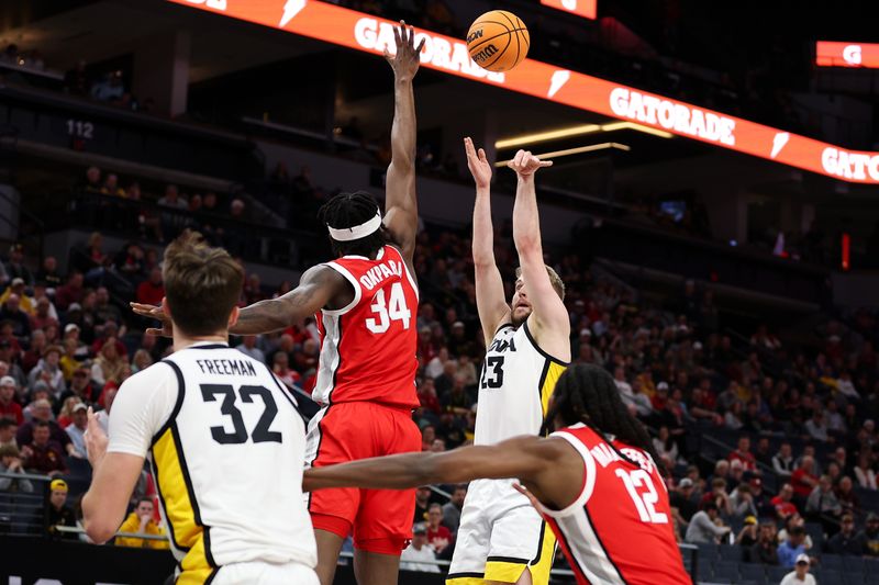 Mar 14, 2024; Minneapolis, MN, USA; Iowa Hawkeyes forward Ben Krikke (23) shoots as Ohio State Buckeyes center Felix Okpara (34) defends during the first half at Target Center. Mandatory Credit: Matt Krohn-USA TODAY Sports