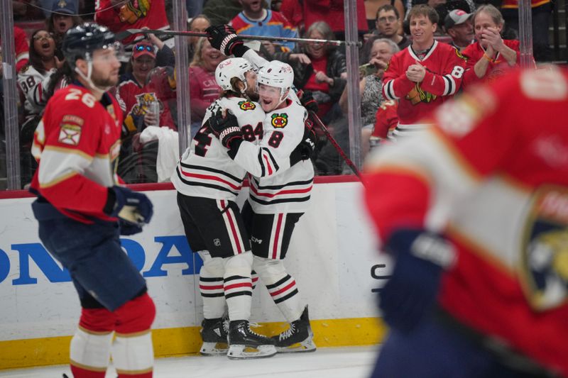 Feb 1, 2025; Sunrise, Florida, USA; Chicago Blackhawks left wing Landon Slaggert (84) celebrates his goal against the Florida Panthers with center Ryan Donato (8) in the first period at Amerant Bank Arena. Mandatory Credit: Jim Rassol-Imagn Images