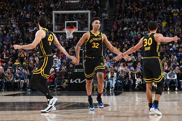 SAN FRANCISCO, CA - DECEMBER 23: Dario Saric #20, Trayce Jackson-Davis #32 and Stephen Curry #30 of the Golden State Warriors high five during the game against the Portland Trail Blazers on December 23, 2023 at Chase Center in San Francisco, California. NOTE TO USER: User expressly acknowledges and agrees that, by downloading and or using this photograph, user is consenting to the terms and conditions of Getty Images License Agreement. Mandatory Copyright Notice: Copyright 2023 NBAE (Photo by Noah Graham/NBAE via Getty Images)