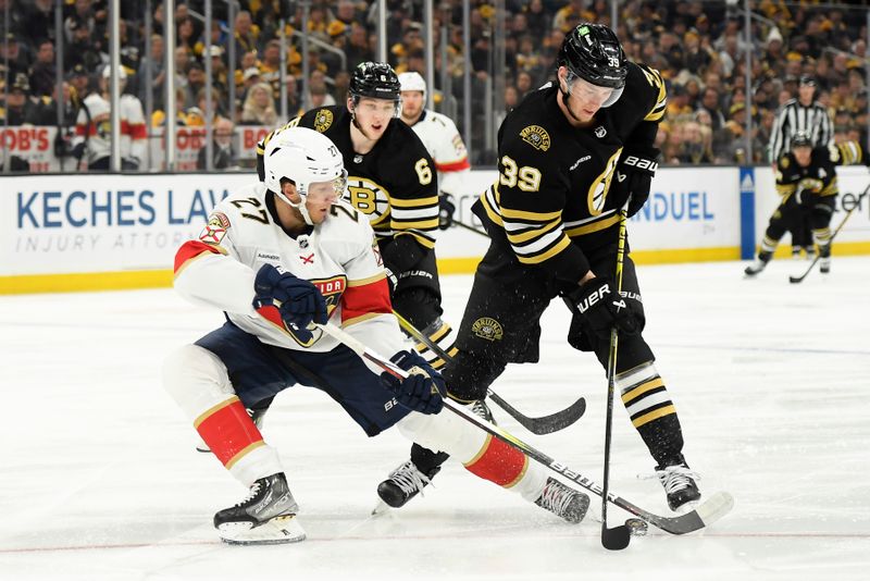 May 12, 2024; Boston, Massachusetts, USA; Florida Panthers center Eetu Luostarinen (27) and Boston Bruins center Morgan Geekie (39) battle for the puck during the second period in game four of the second round of the 2024 Stanley Cup Playoffs at TD Garden. Mandatory Credit: Bob DeChiara-USA TODAY Sports