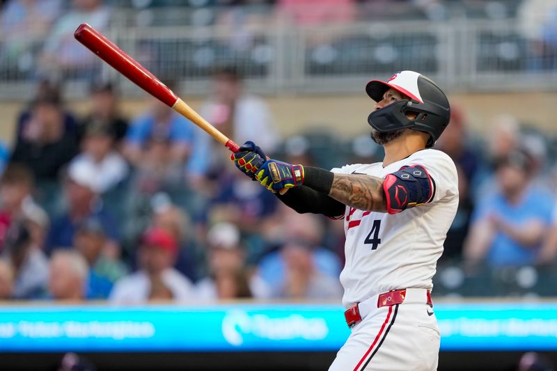 May 8, 2024; Minneapolis, Minnesota, USA; Minnesota Twins shortstop Carlos Correa (4) hits a solo home run against the Seattle Mariners in the first inning at Target Field. Mandatory Credit: Jesse Johnson-USA TODAY Sports