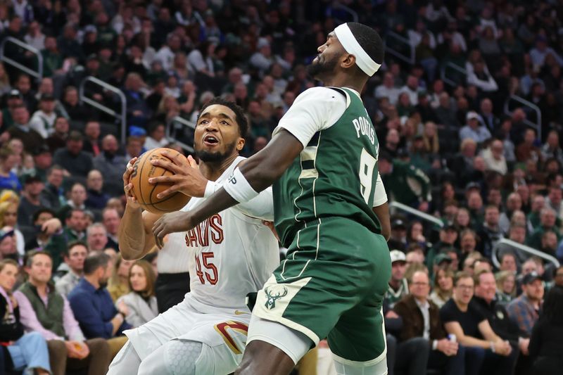 MILWAUKEE, WISCONSIN - JANUARY 24: Donovan Mitchell #45 of the Cleveland Cavaliers is defended by Bobby Portis #9 of the Milwaukee Bucks during a game at Fiserv Forum on January 24, 2024 in Milwaukee, Wisconsin. NOTE TO USER: User expressly acknowledges and agrees that, by downloading and or using this photograph, User is consenting to the terms and conditions of the Getty Images License Agreement. (Photo by Stacy Revere/Getty Images)