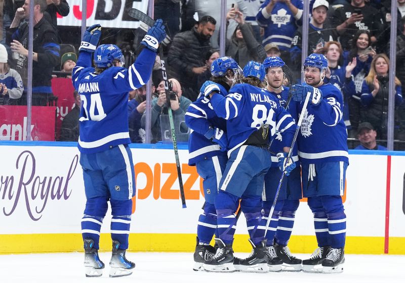 Apr 8, 2024; Toronto, Ontario, CAN; Toronto Maple Leafs defenseman Jake McCabe (22) scores the winning goal and celebrates with teammates against the Pittsburgh Penguins during the overtime period at Scotiabank Arena. Mandatory Credit: Nick Turchiaro-USA TODAY Sports