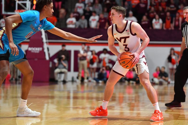 Feb 13, 2024; Blacksburg, Virginia, USA; Florida State Seminoles forward Baba Miller (11) defends Virginia Tech Hokies guard Sean Pedulla (3) during the second half at Cassell Coliseum. Mandatory Credit: Brian Bishop-USA TODAY Sports