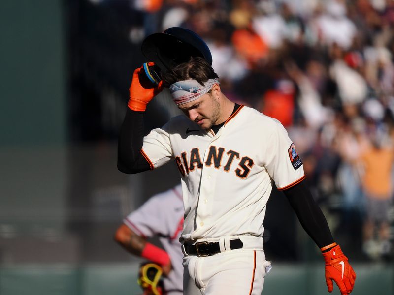 Aug 27, 2023; San Francisco, California, USA; San Francisco Giants catcher Patrick Bailey (14) removes his batting helmet after hitting a three-run RBI double against the Atlanta Braves during the fifth inning at Oracle Park. Mandatory Credit: Kelley L Cox-USA TODAY Sports