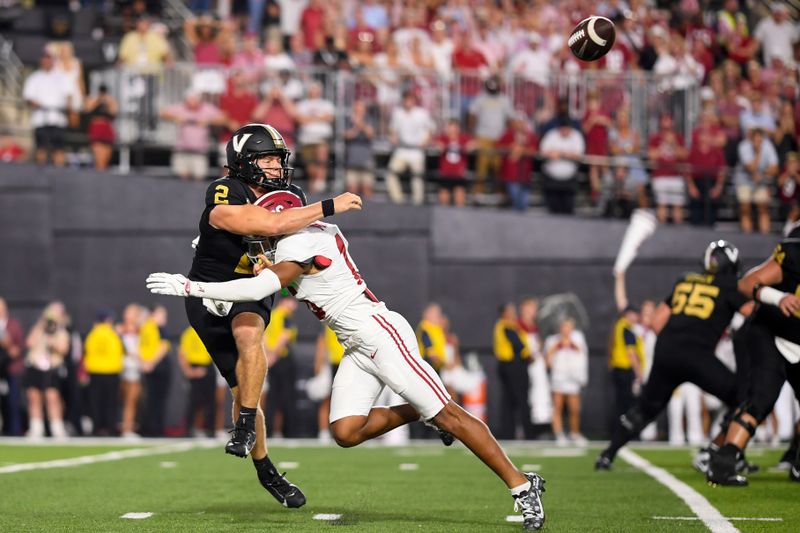 Oct 5, 2024; Nashville, Tennessee, USA;  Vanderbilt Commodores quarterback Diego Pavia (2) throws the ball as he is hit by Alabama Crimson Tide defensive back Red Morgan (16) during the second half at FirstBank Stadium. Mandatory Credit: Steve Roberts-Imagn Images