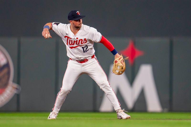 Sep 9, 2024; Minneapolis, Minnesota, USA; Minnesota Twins second baseman Kyle Farmer (12) throws to first for an out against the Los Angeles Angels in the ninth inning at Target Field. Mandatory Credit: Jesse Johnson-Imagn Images