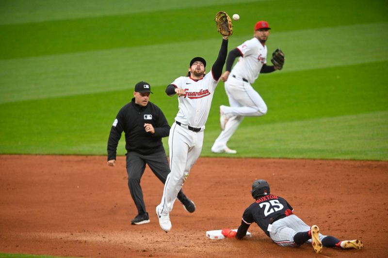 Apr 30, 2025; Cleveland, Ohio, USA; Cleveland Guardians second baseman Daniel Schneemann (10) reaches for the ball as Minnesota Twins center fielder Byron Buxton (25) steals second base in the sixth inning at Progressive Field. Mandatory Credit: David Richard-Imagn Images