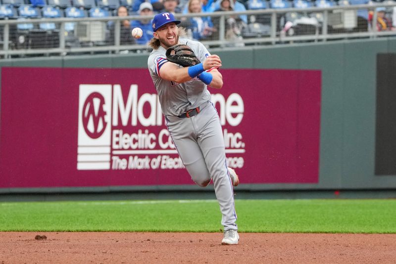 May 5, 2024; Kansas City, Missouri, USA; Texas Rangers outfielder Travis Jankowski (16) fields a ball and throws to first against the Kansas City Royals in the ninth inning at Kauffman Stadium. Mandatory Credit: Denny Medley-USA TODAY Sports