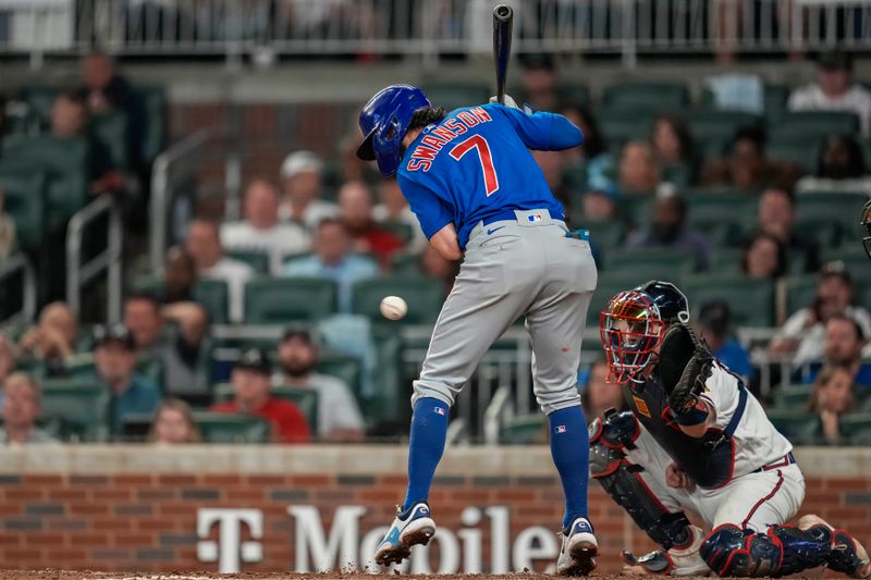 Sep 27, 2023; Cumberland, Georgia, USA; Chicago Cubs shortstop Dansby Swanson (7) is hit by a pitch against the Atlanta Braves during the ninth inning at Truist Park. Mandatory Credit: Dale Zanine-USA TODAY Sports