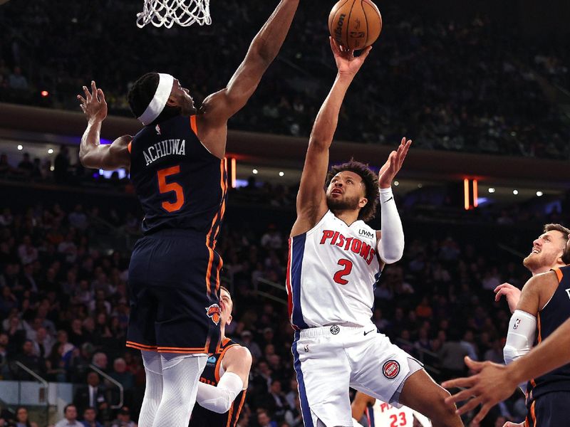 NEW YORK, NEW YORK - FEBRUARY 26: Cade Cunningham #2 of the Detroit Pistons heads for the net as Precious Achiuwa #5 of the New York Knicks defends during the first half at Madison Square Garden on February 26, 2024 in New York City. NOTE TO USER: User expressly acknowledges and agrees that, by downloading and or using this photograph, User is consenting to the terms and conditions of the Getty Images License Agreement. (Photo by Elsa/Getty Images)